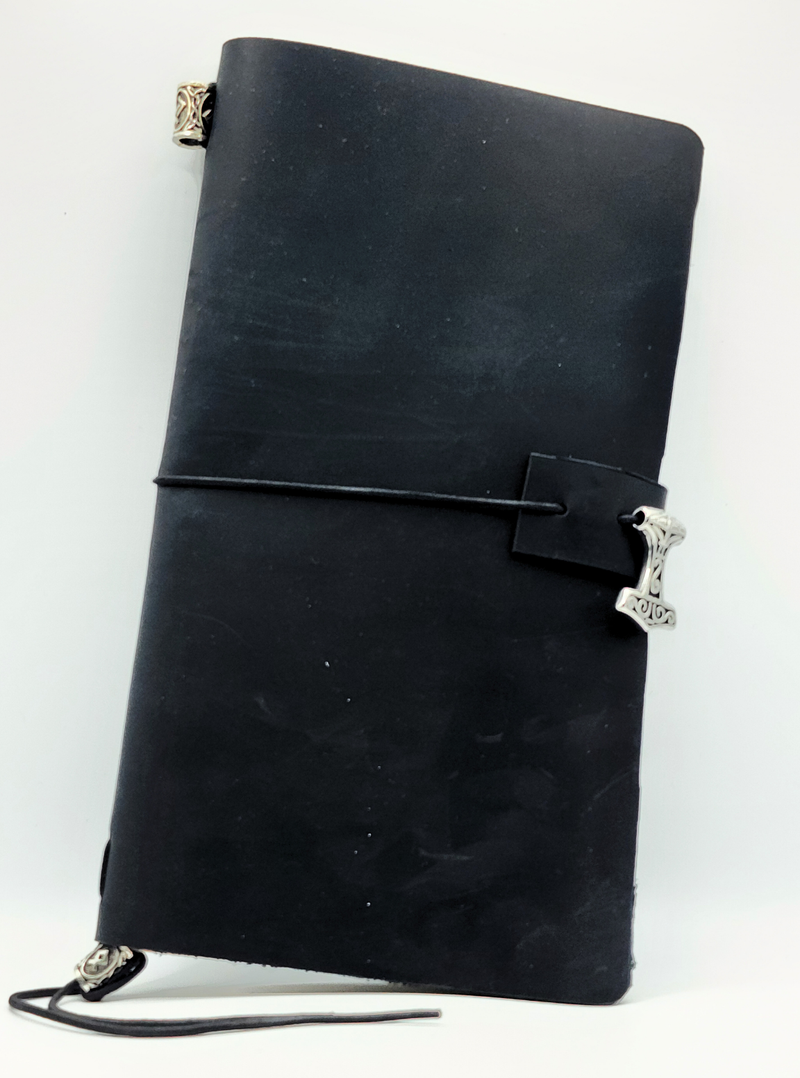 Odyssey Notebook – custom leather travel journal in brown and black with Nordic rune designs and Thor’s Hammer motif